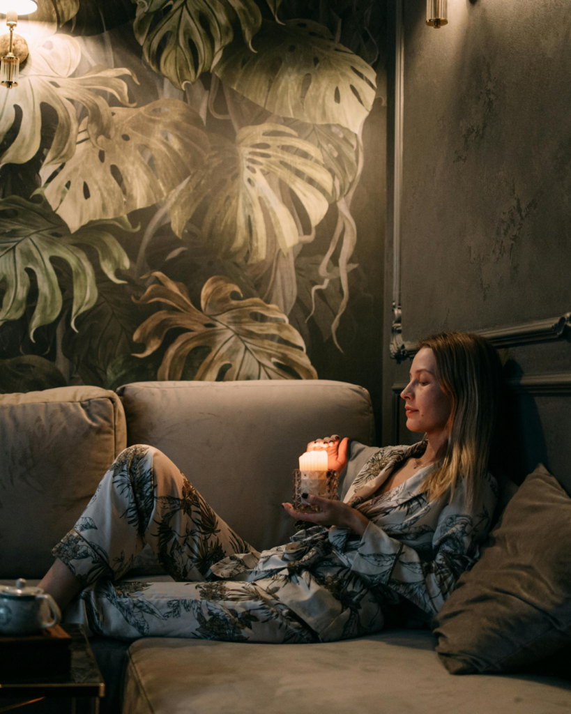 Eine Frau auf der Couch mit Kerzenlicht
