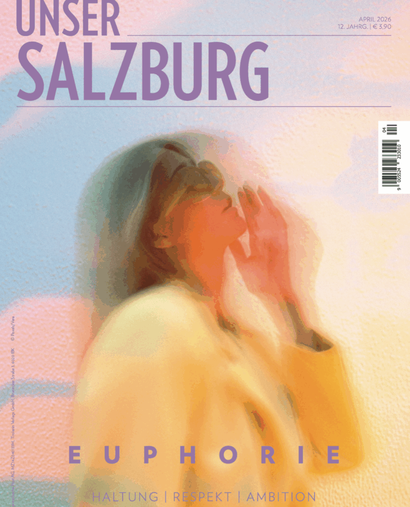 Coverbild Unser SALZBURG April 2026 mit Coverwort Euphorie. Dame mit gelben Blazer, verschwommenes Bild