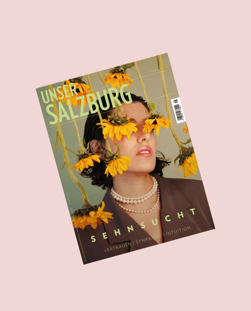Coverbild Unser SALZBURG MAI-Ausgabe, eine Frau mit hängenden Sonnenblumen vorm Gesicht
