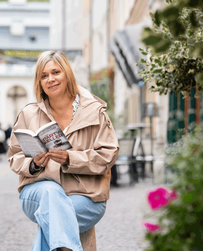 Portraitbild von Claudia Held mit Krimibuch in der Hand